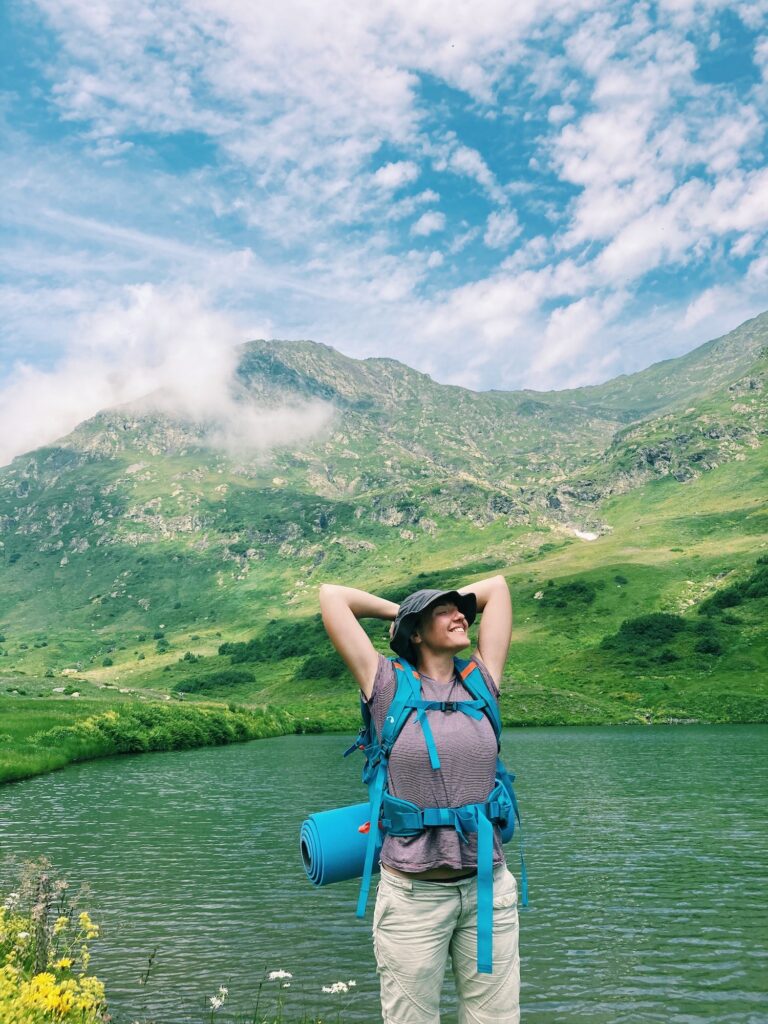 happy woman hiker by the mountain lake